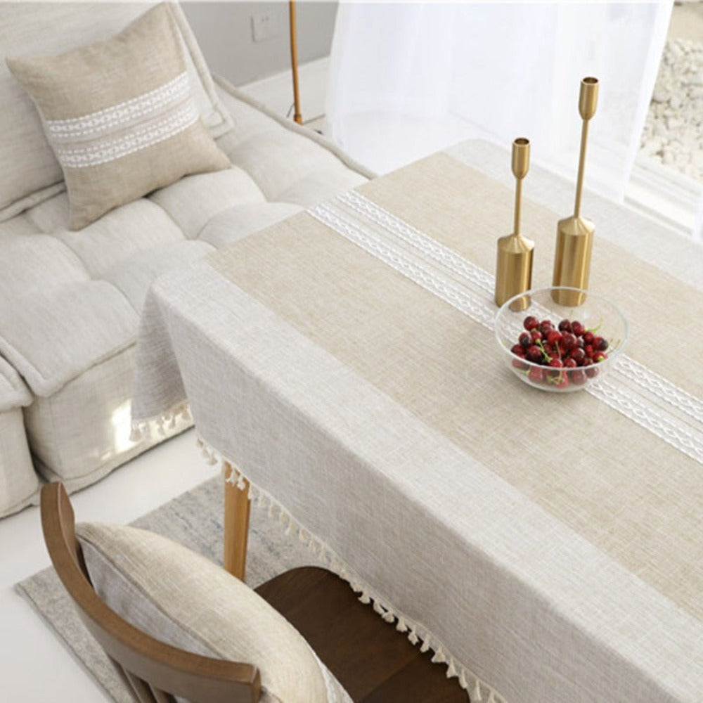 Mantel Rectangular café claro en laterales con franja central de tono más oscuro con bordados blancos centrales y borde de borlas de color beige, lo puedes usar para decorar tus mesas de comedor, comedor de diario y mesas en general de tus espacios y hogar. Mantel rectangular Color: Café Claro Con Borlas color crema en el borde Material: Lino Mantel tiene medidas de 140 cm x 220 cm y 140 cm x 200 cm.